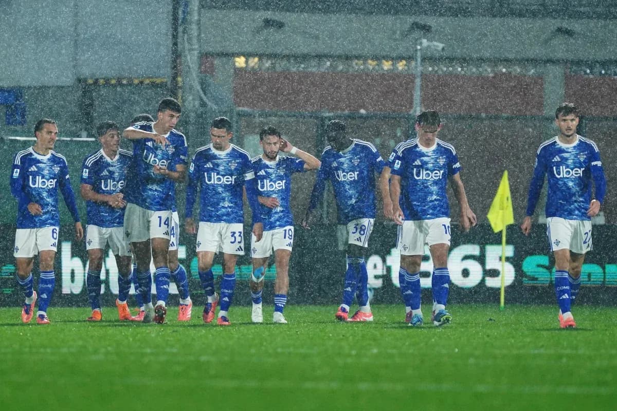Como players celebrating in heavy rain during match Como players celebrating in heavy rain during match