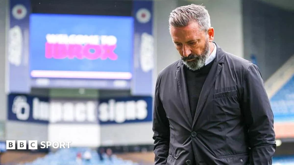 Coach walking with head down at Ibrox Stadium Coach walking with head down at Ibrox Stadium