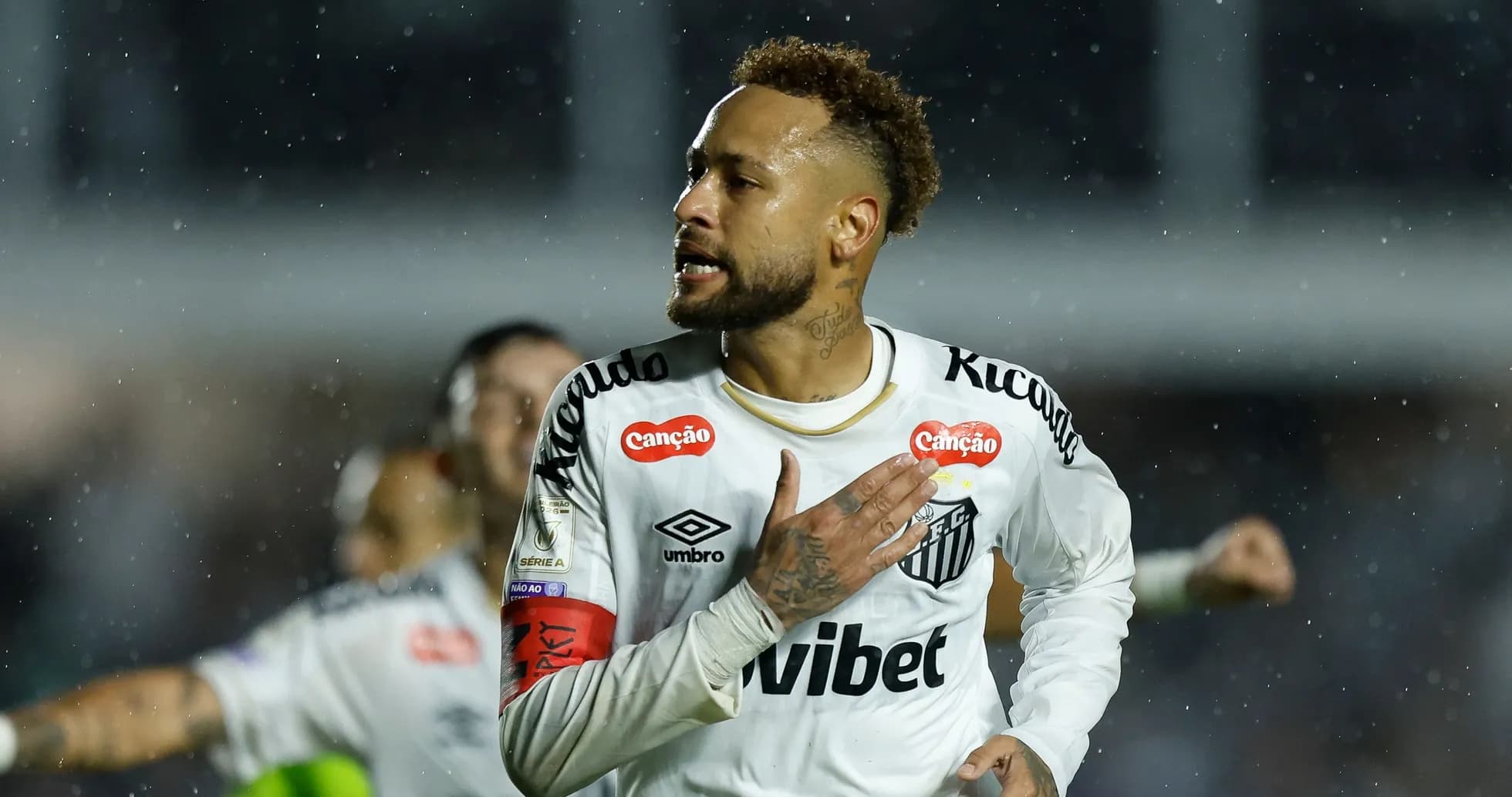 Player celebrating after scoring a goal in rain Player celebrating after scoring a goal in rain