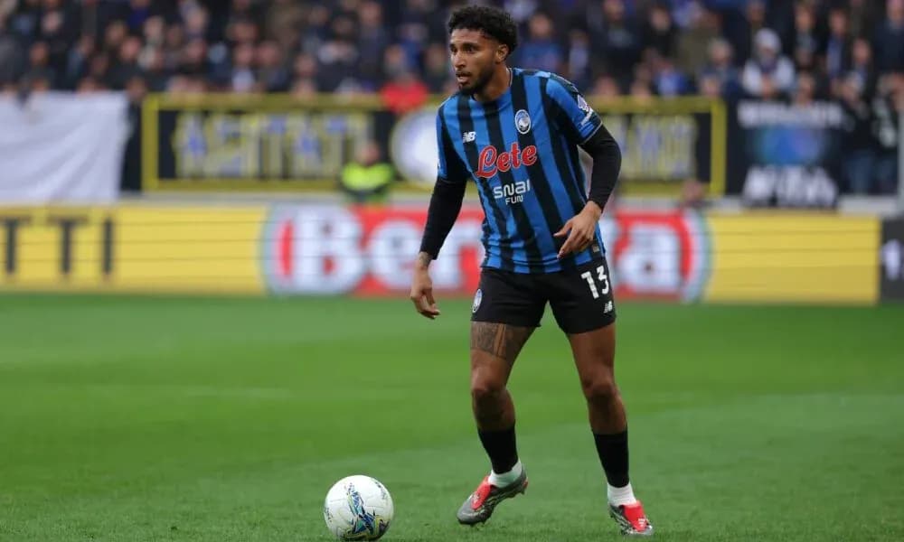 Player in Atalanta kit controlling ball on field Player in Atalanta kit controlling ball on field