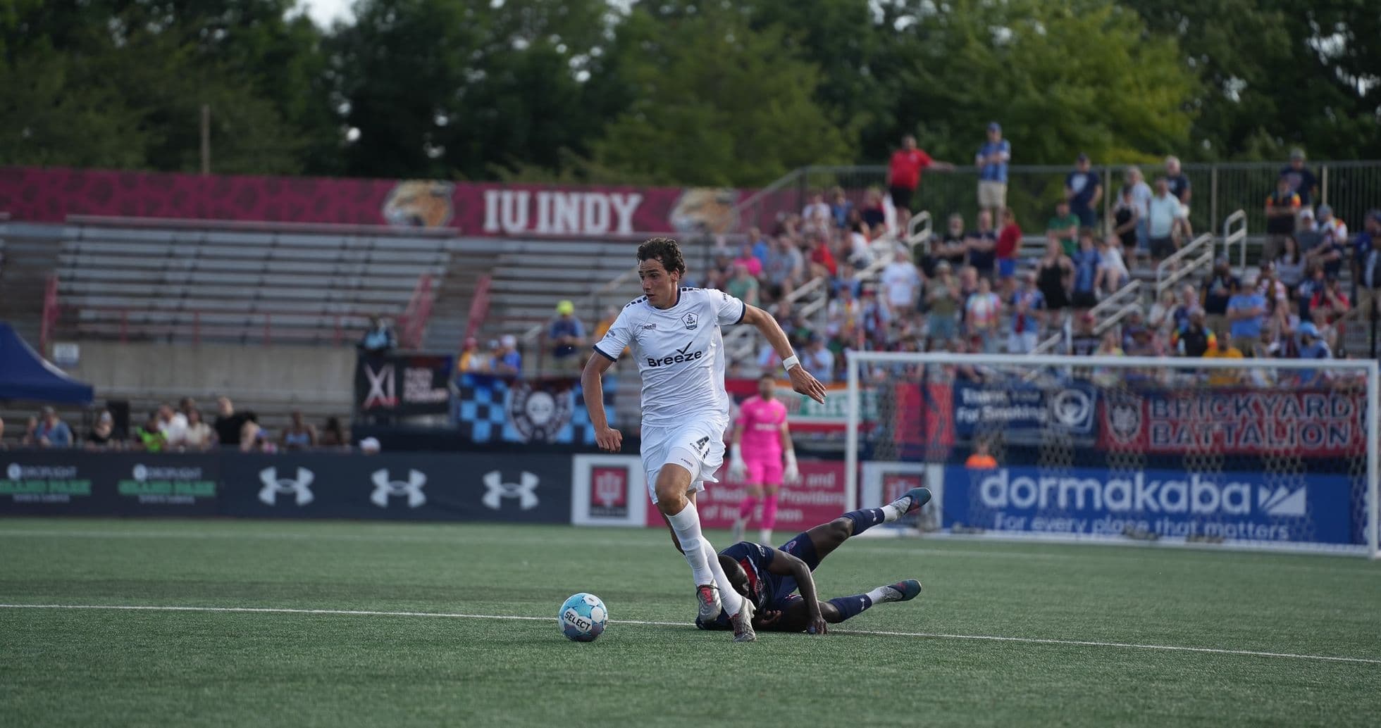 Player evading a tackle during Indy Eleven match Player evading a tackle during Indy Eleven match