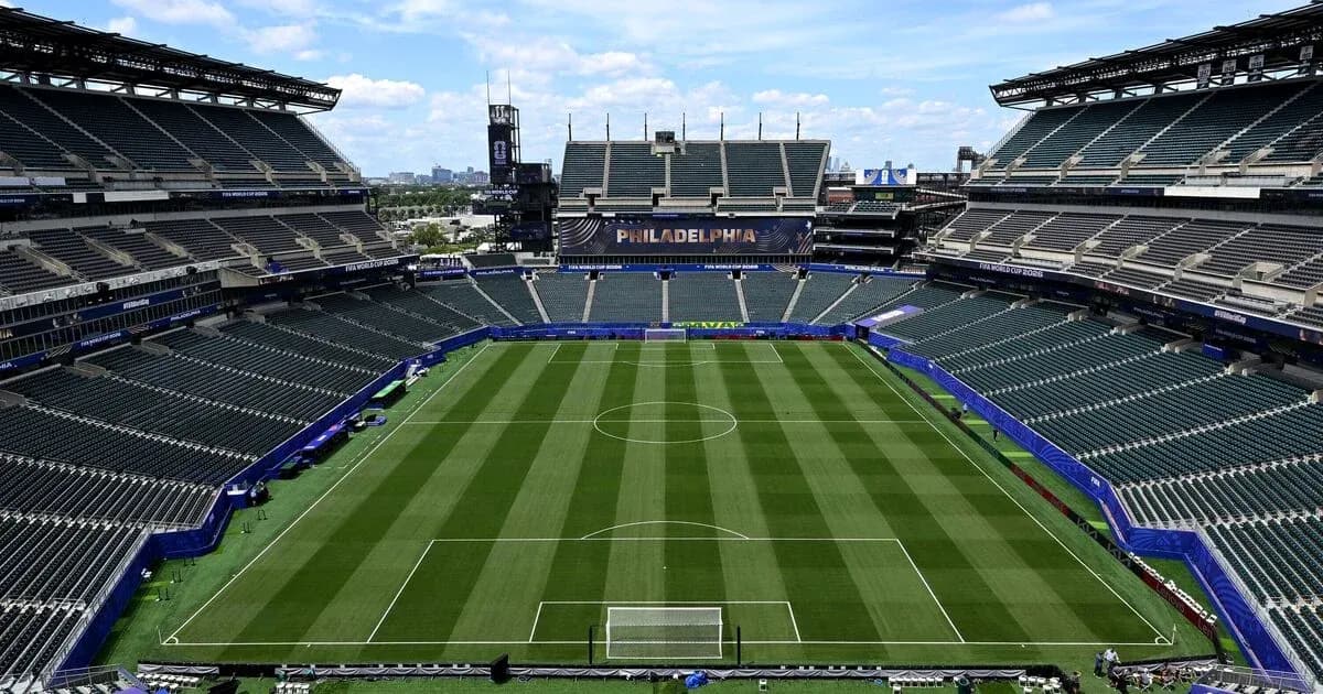 Empty soccer stadium with field and seating area Empty soccer stadium with field and seating area