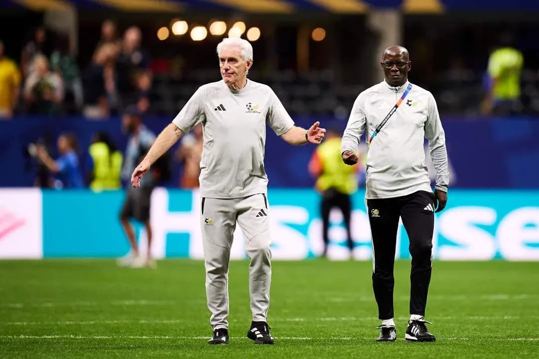 Coaches walking on the pitch before a match Coaches walking on the pitch before a match