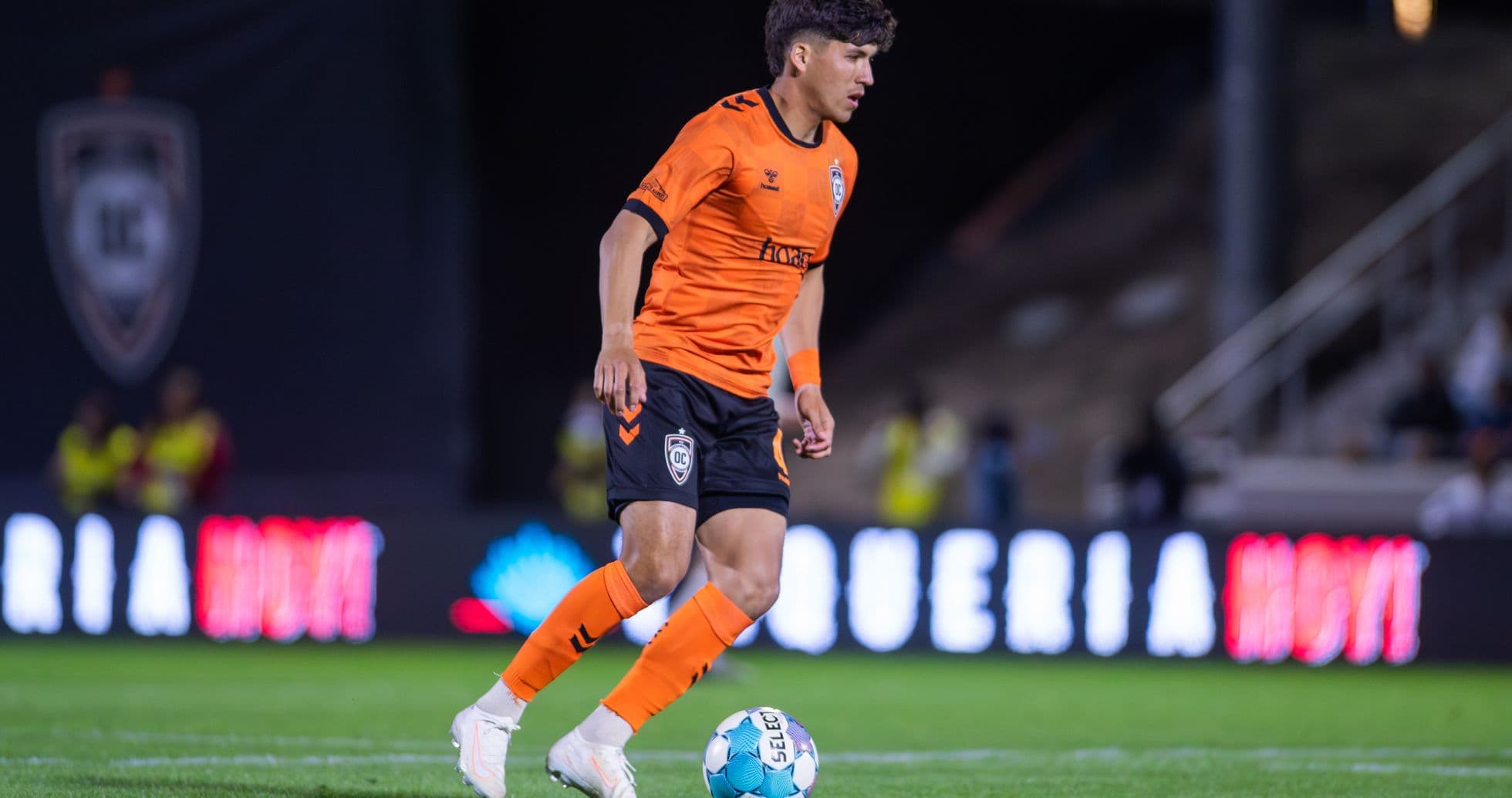 Orange County SC player dribbling the ball Orange County SC player dribbling the ball