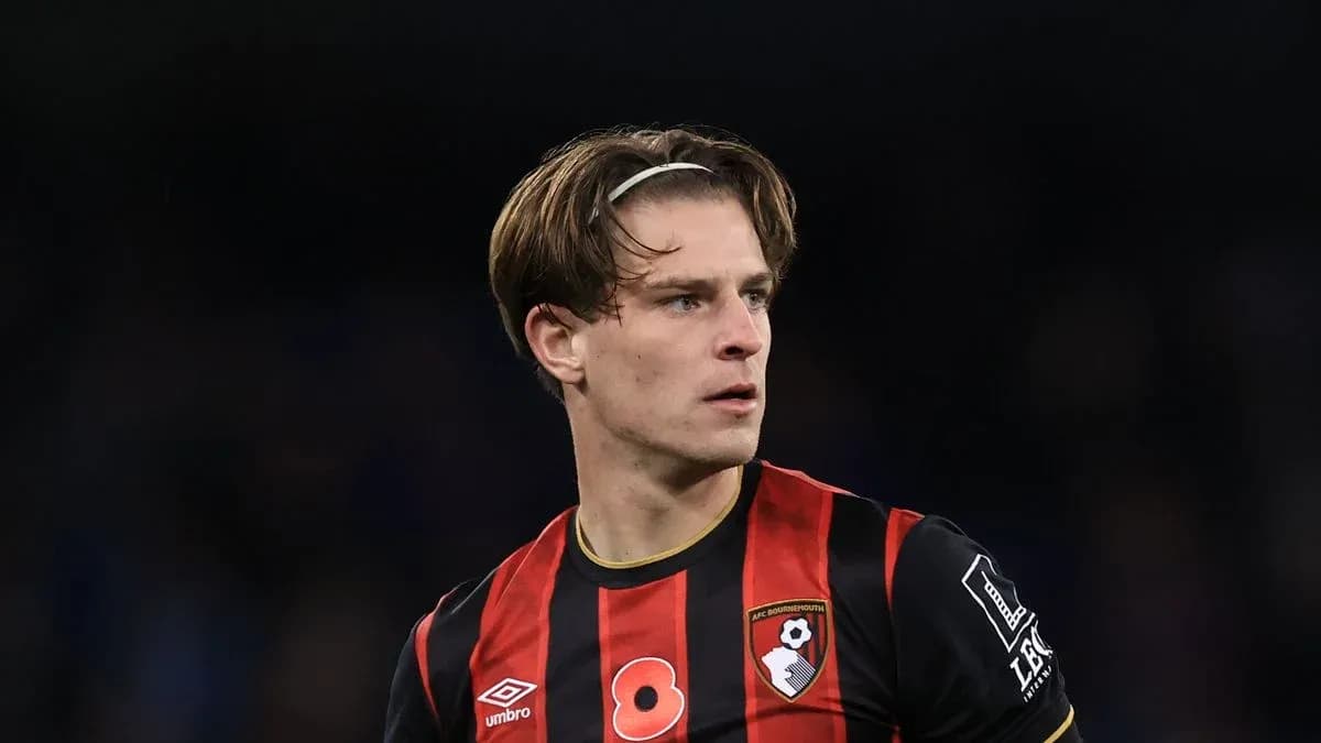 Bournemouth player in black and red kit on pitch Bournemouth player in black and red kit on pitch