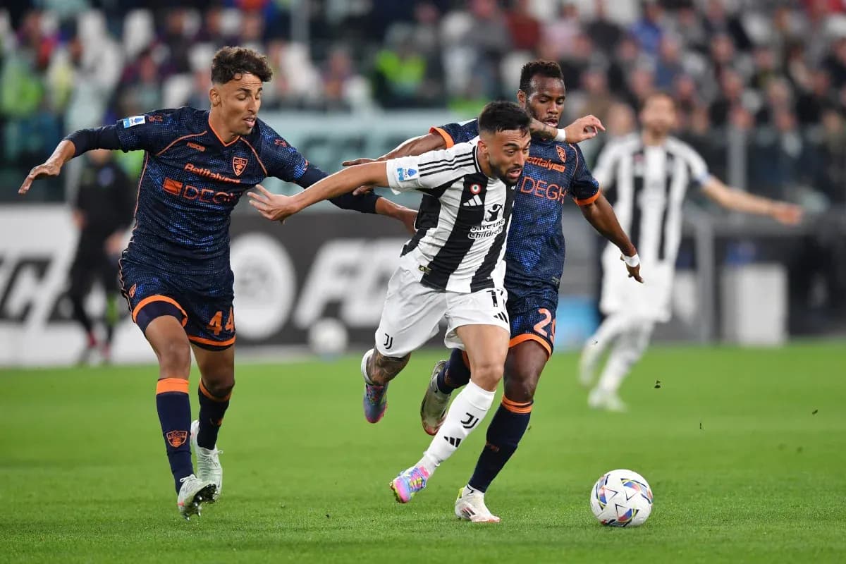 Juventus player evading Lecce defenders during match Juventus player evading Lecce defenders during match