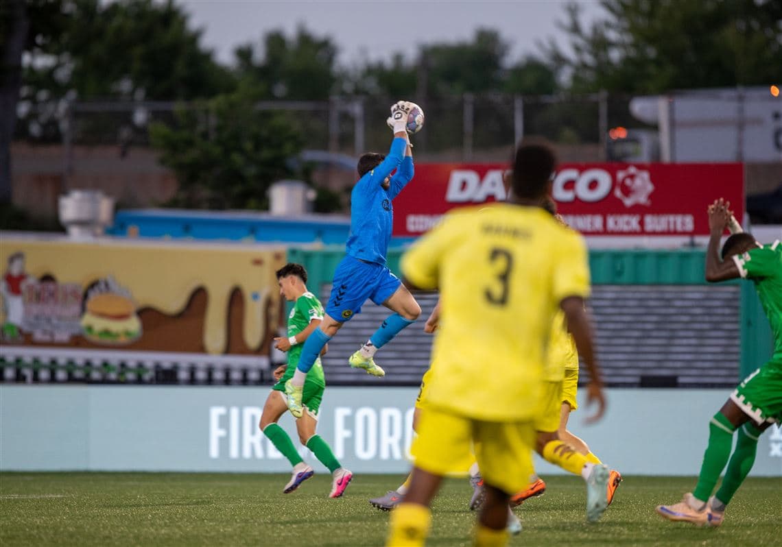 Goalkeeper catching the ball during match Goalkeeper catching the ball during match