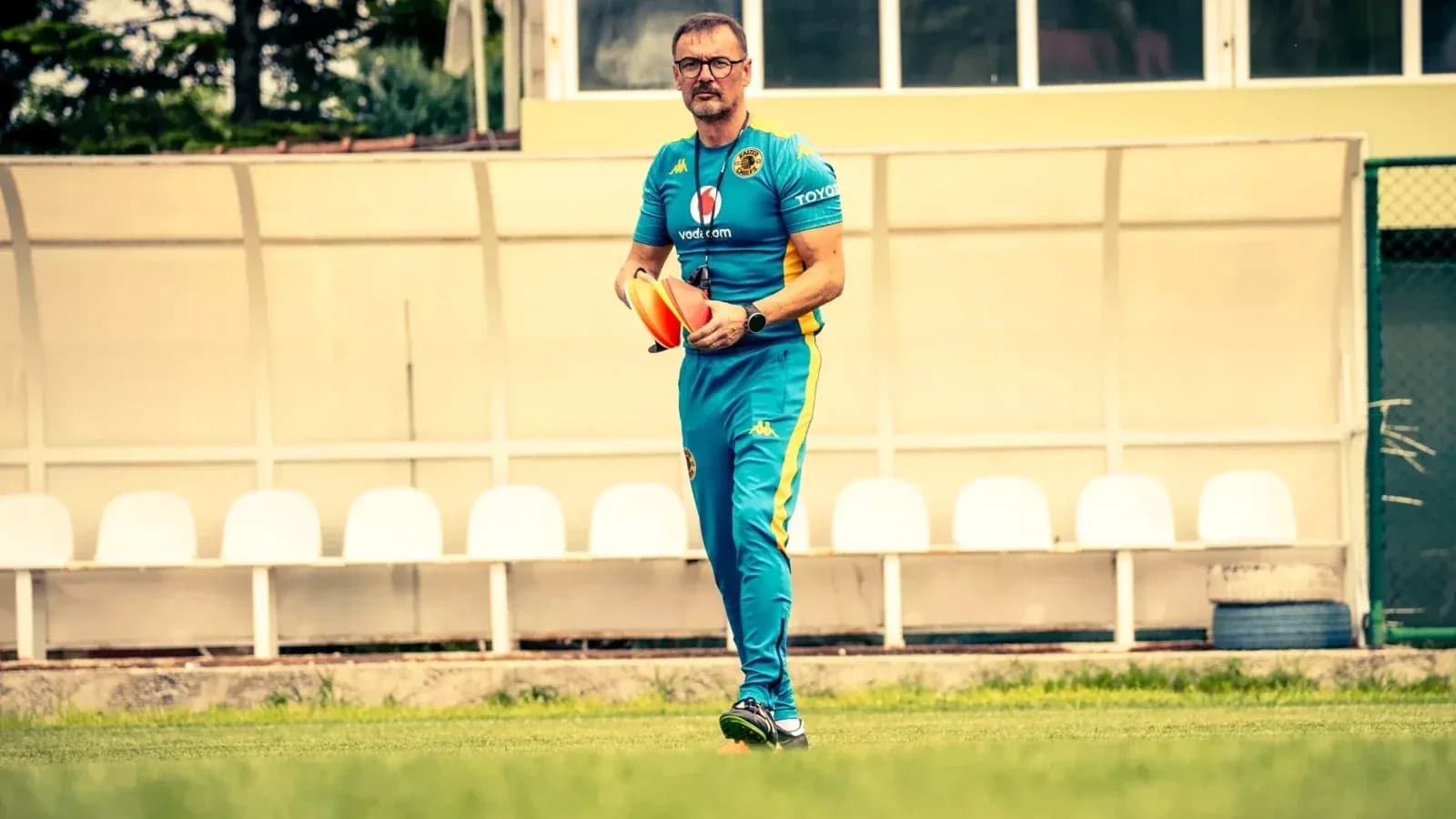 Coach holding training cones on the field Coach holding training cones on the field