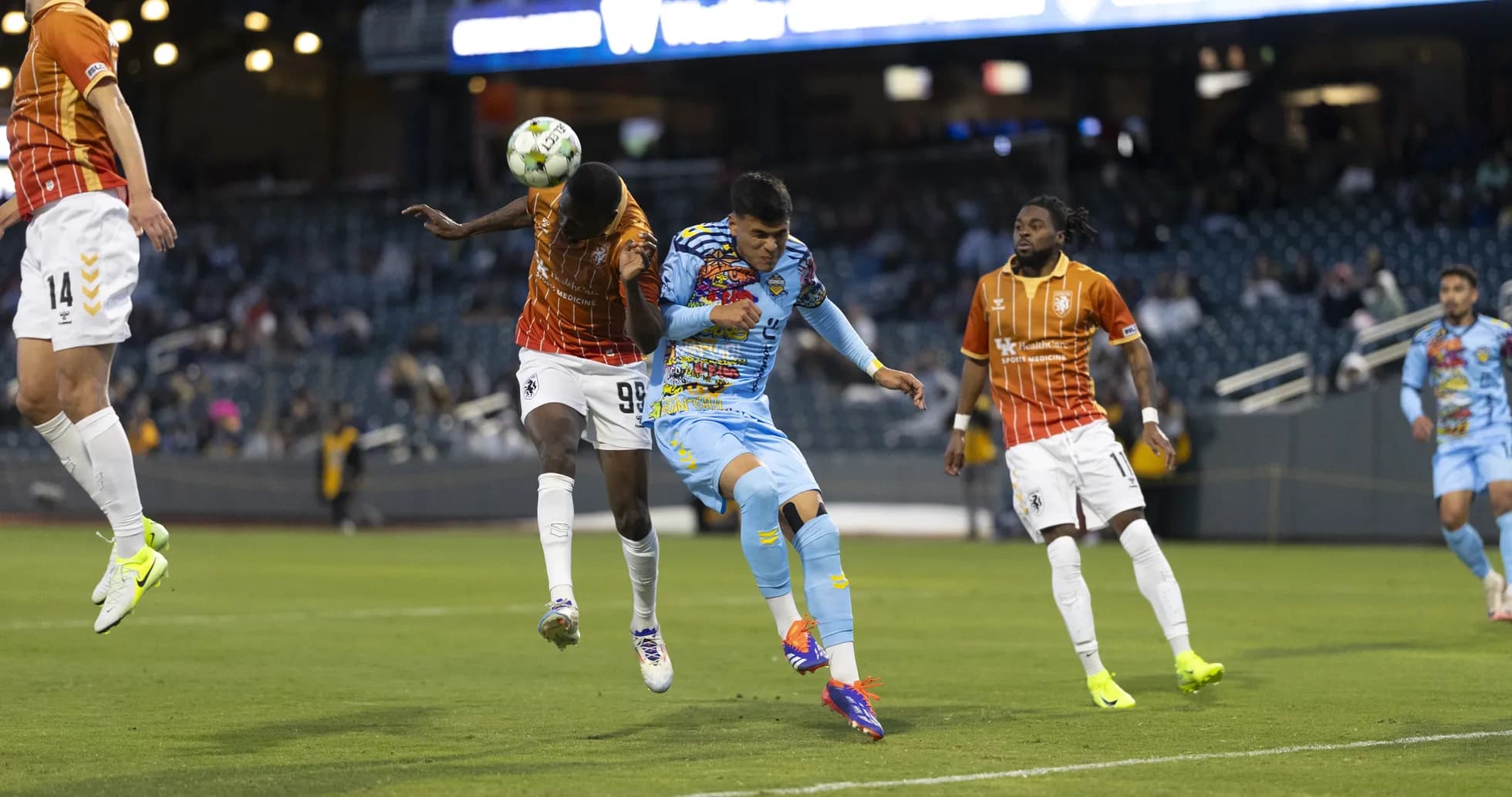 Players competing for the ball in USL match Players competing for the ball in USL match
