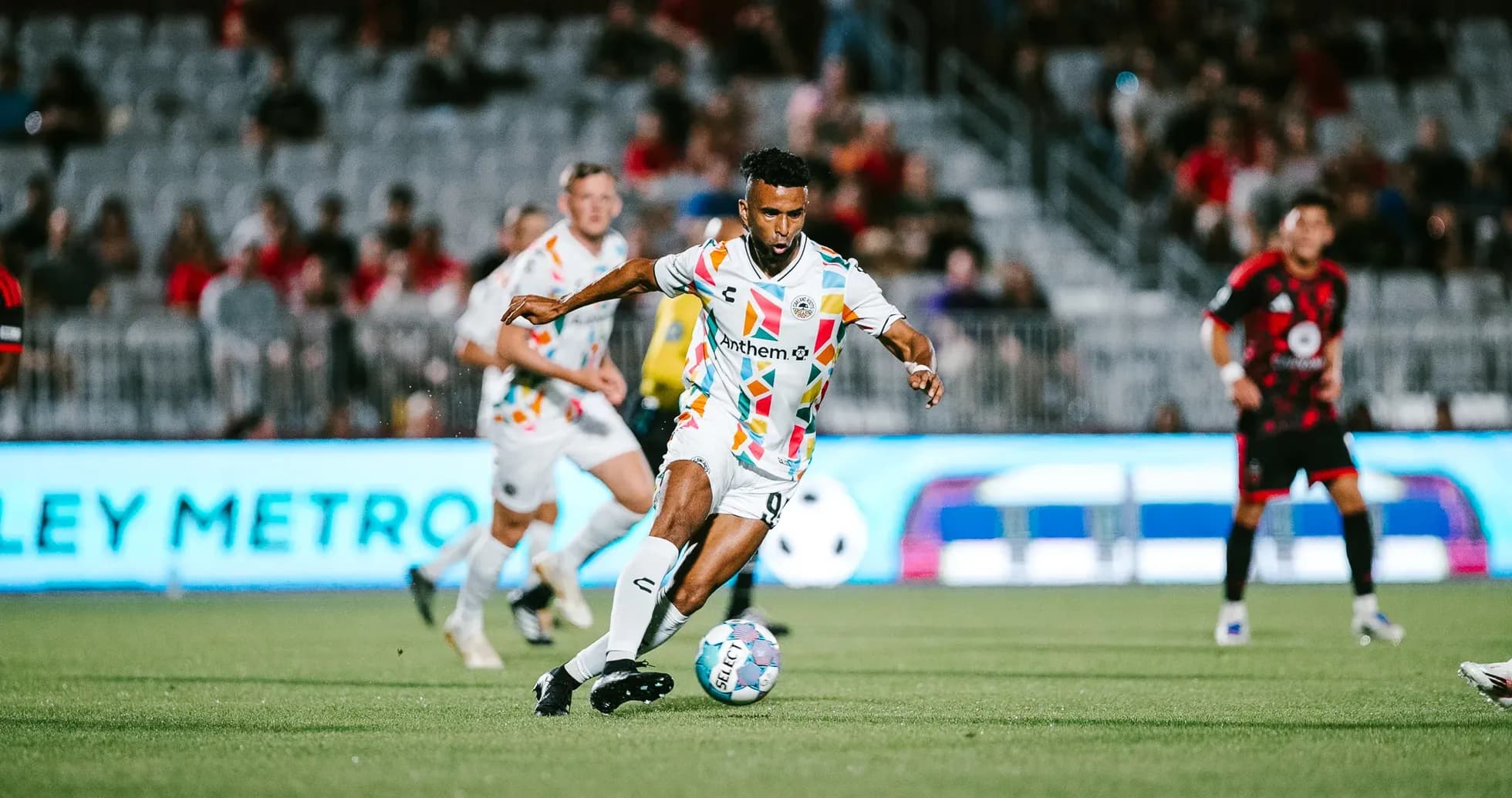 Player dribbling the ball during USL Championship match Player dribbling the ball during USL Championship match